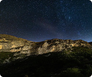 Starry night over mountains
